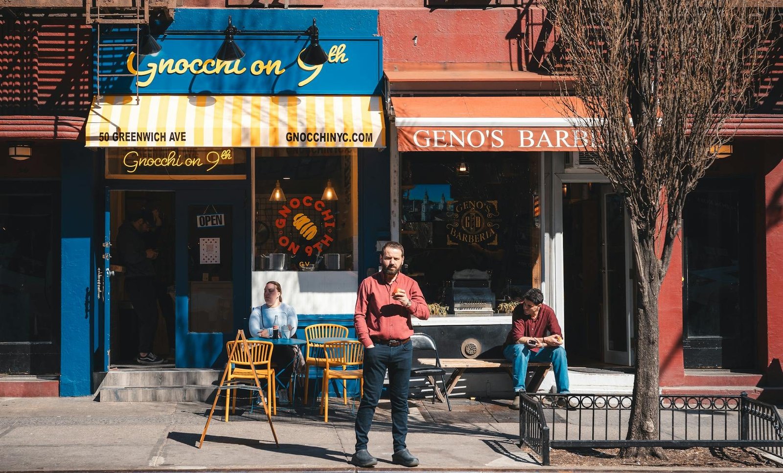 Greenwich Village street scene with Gnocchi on 9th restaurant and people on sidewalk.