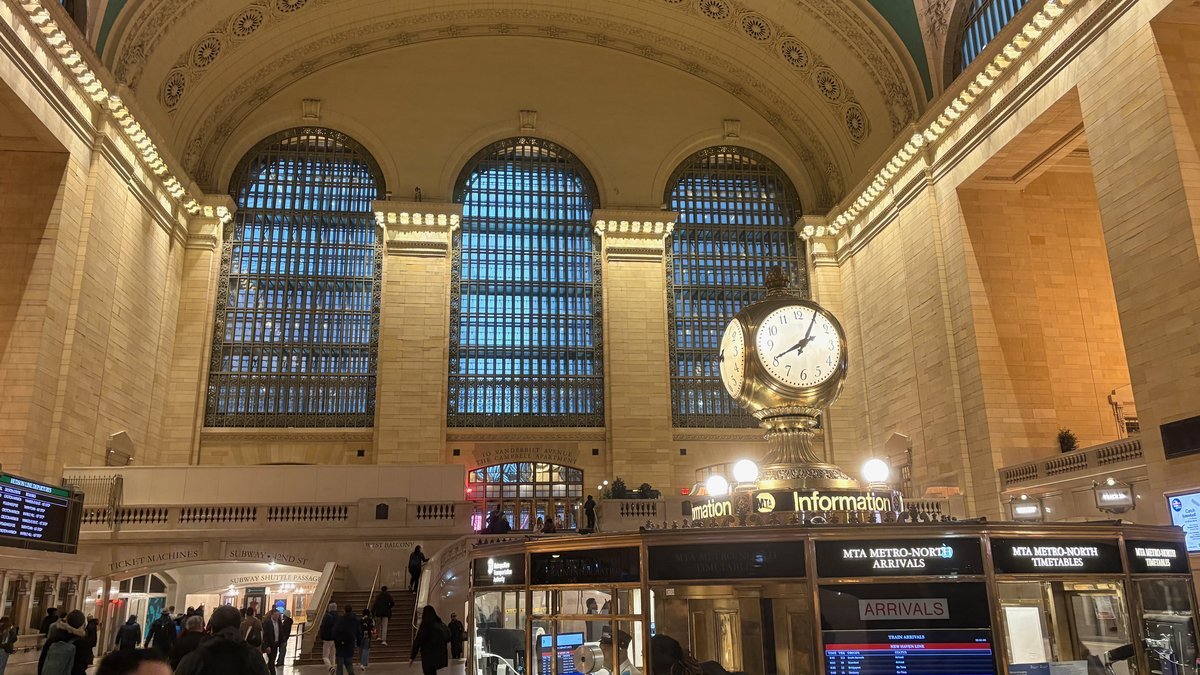 Grand Central Terminal main concourse with iconic clock and arched windows in New York City.