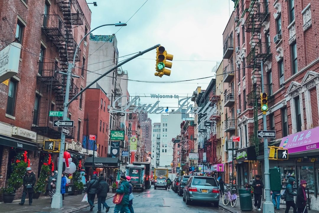Mott Street in Little Italy with historic brick buildings and street signs, charming neighborhoods near day trip Hamptons routes.