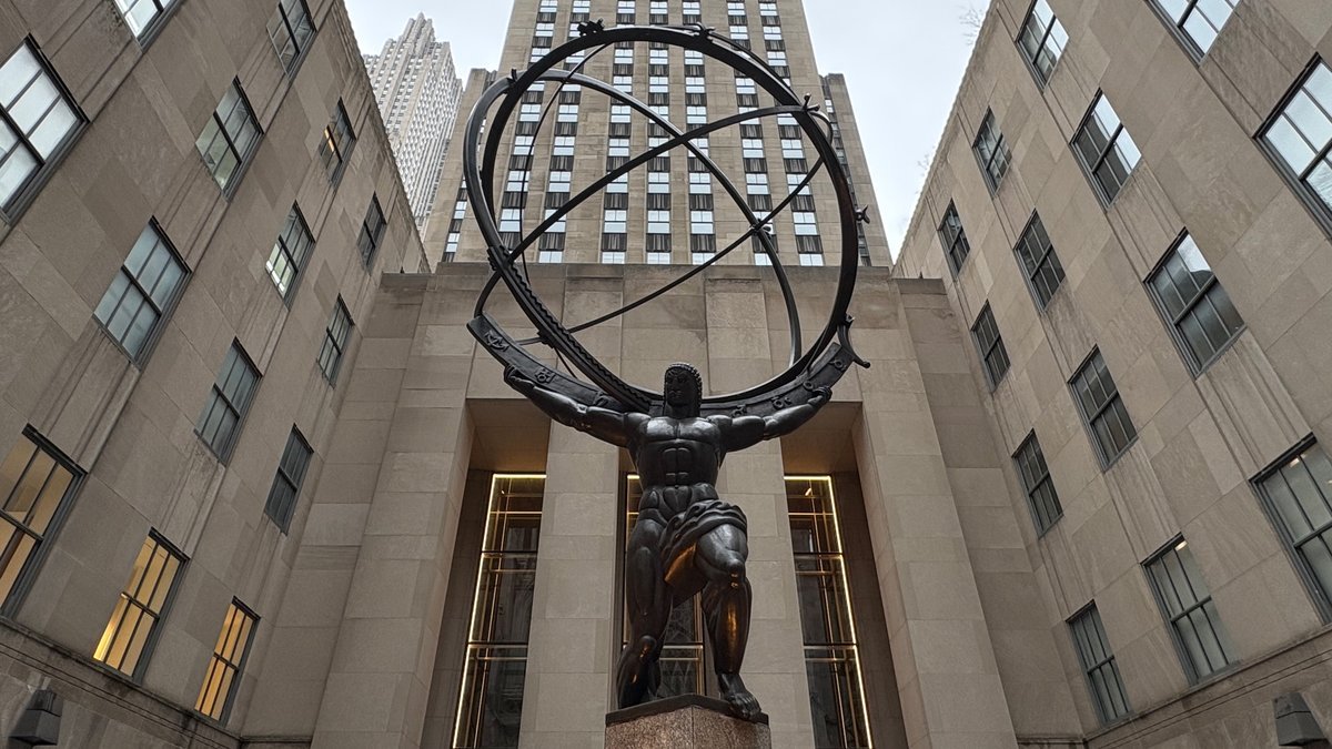 Iconic Atlas statue at Rockefeller Center, New York City, with towering Art Deco buildings.