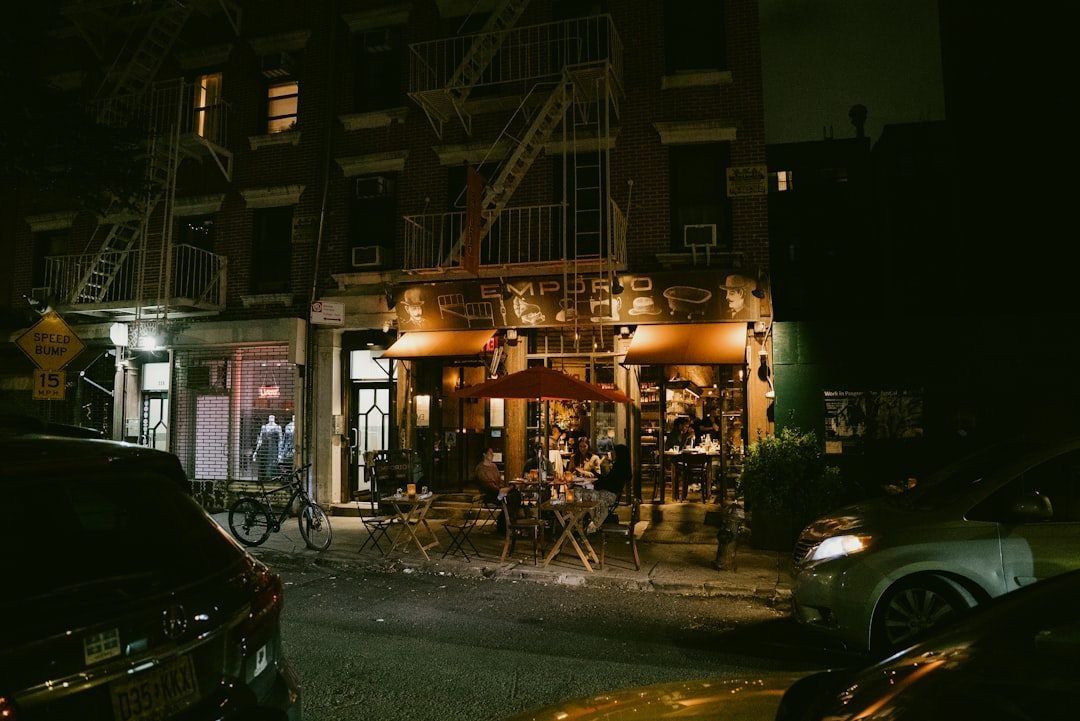 Emporio restaurant in Nolita, NYC, at night with outdoor dining and warm lights.