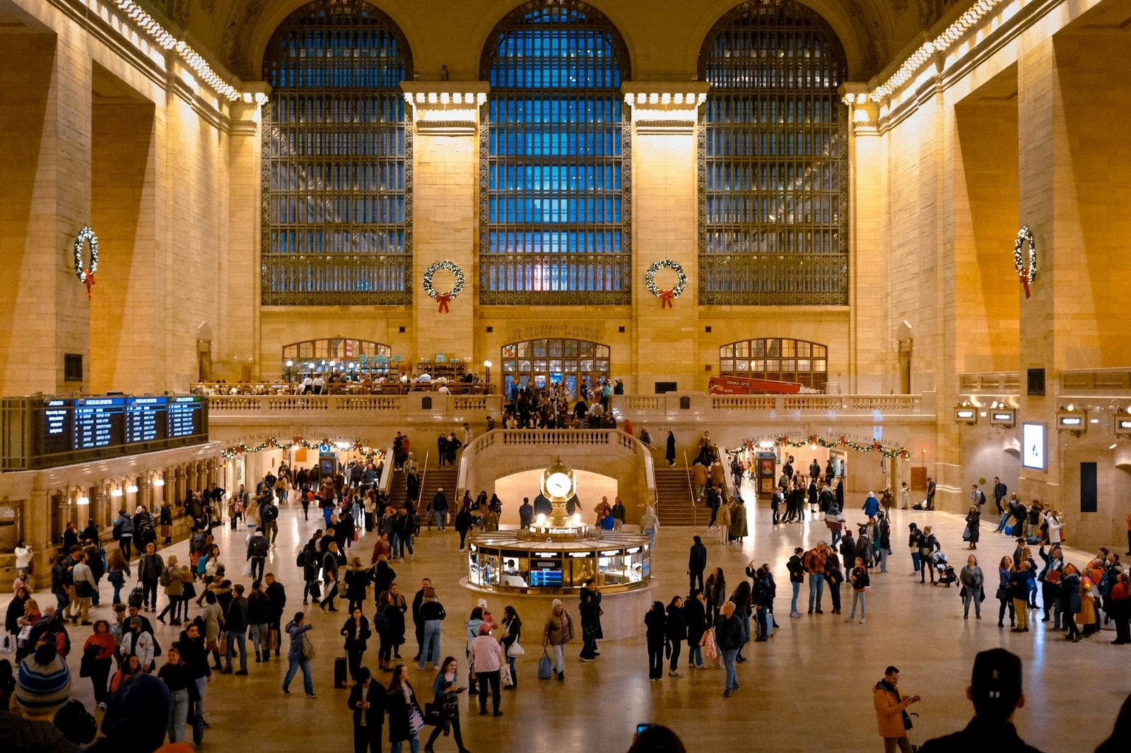 Grand Central Terminal main concourse in New York City, bustling with travelers and festive decor.