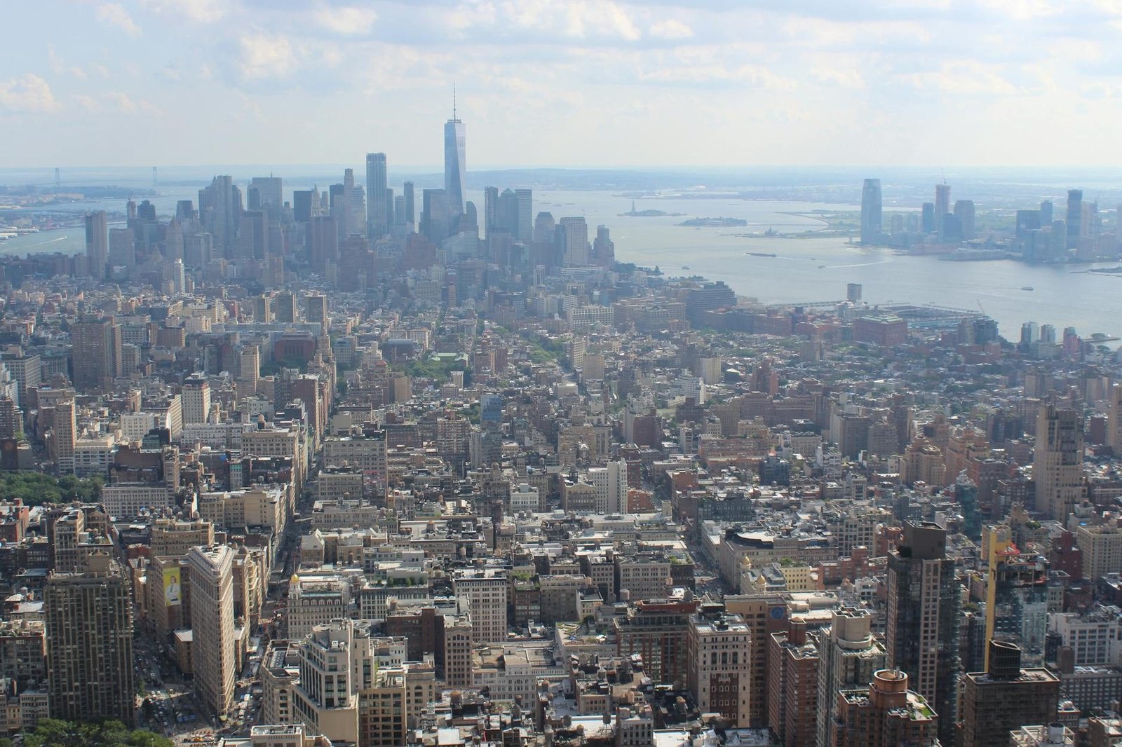 Aerial view of New York City skyline with One World Trade Center and Flatiron Building.