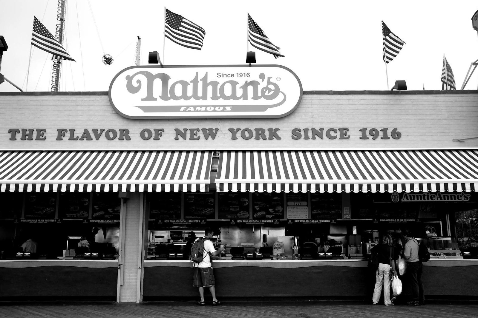Nathan's Famous hot dog stand in Coney Island, New York City, black and white.