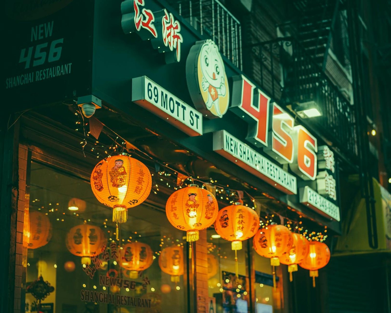 New 456 Shanghai Restaurant on Mott Street, Chinatown, with glowing lanterns at night.