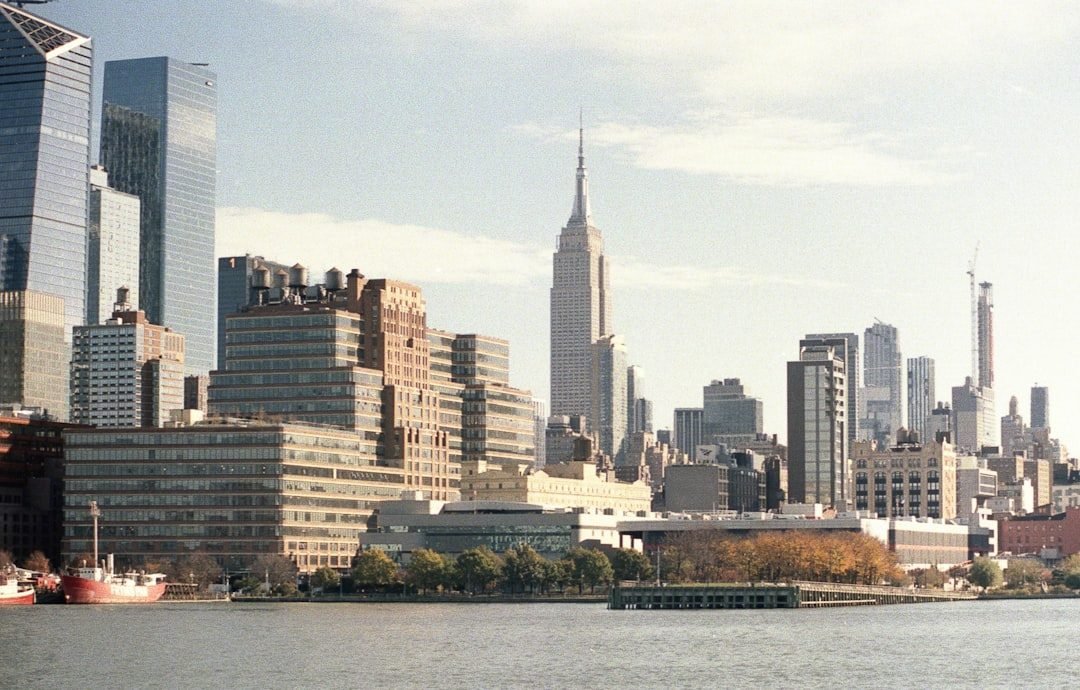New York City skyline from Hudson River with Empire State Building and modern towers.