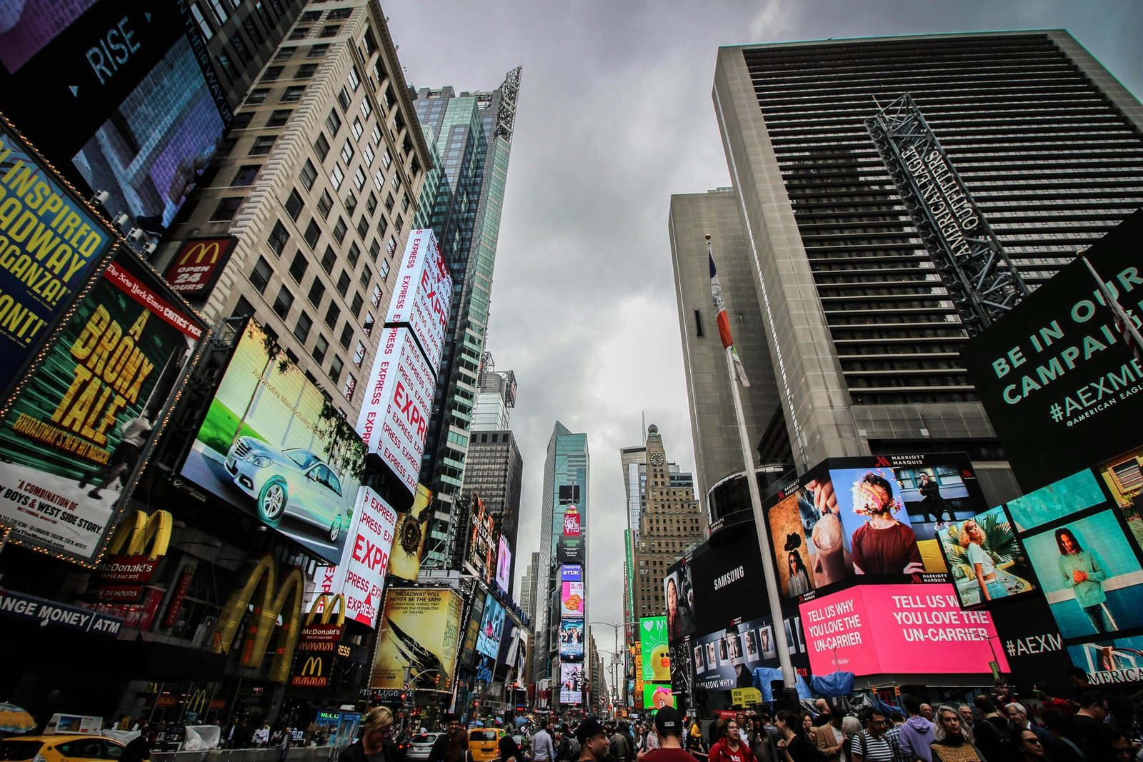 Times Square at night with bright digital billboards and yellow cabs